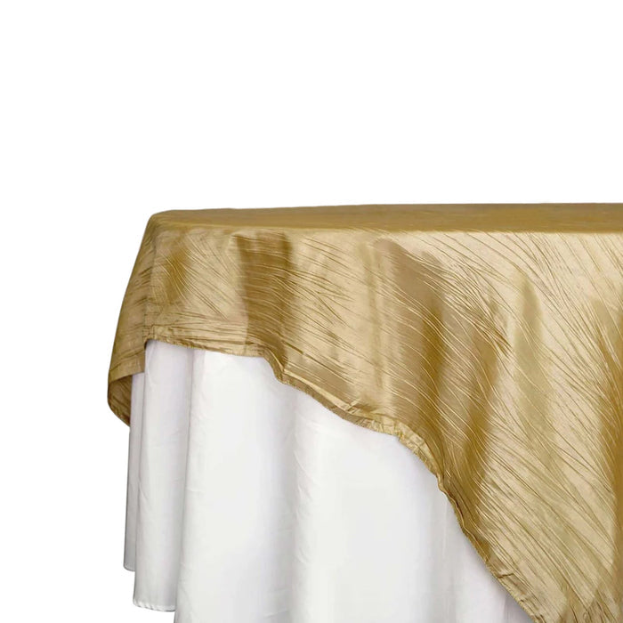 Gold tablecloth with a textured finish draped over a white table