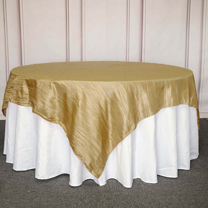 Gold tablecloth draped over a round table with a white skirt.