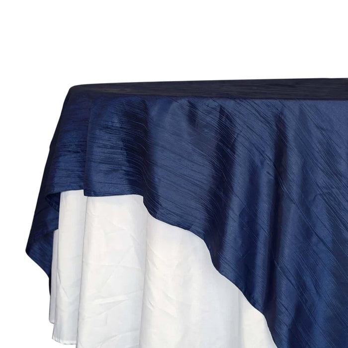 Navy blue tablecloth with white underlay for elegant dining setups