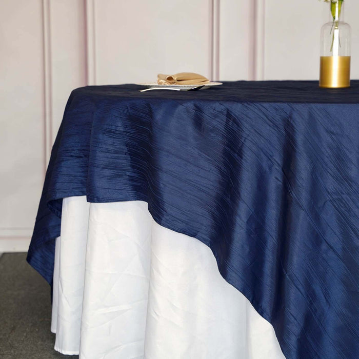 Navy blue tablecloth with white hem on a table setting.