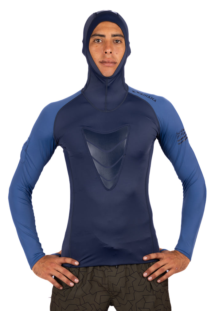 Male model wearing the Waihana Vista Hooded Spearfishing Rashguard in two-tone navy and steel blue, with a structured chest panel and full hood, shown from the front against a white studio background.
